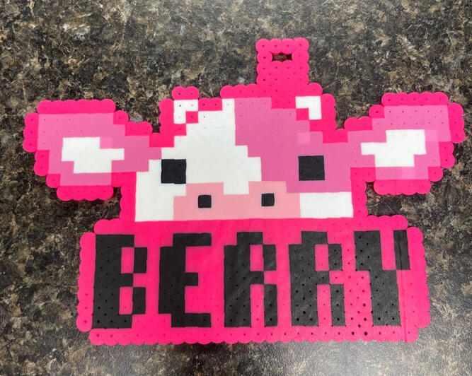 Cow perler badge with the name Berry on it